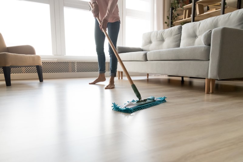 Como organizar um apartamento | Foto de uma mulher limpando a sala de casa | Guia da Tenda | Blog da Tenda
