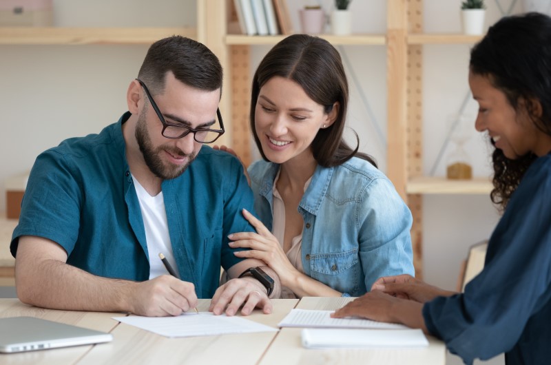 Quem tem direito ao subsídio do Minha Casa, Minha Vida | Foto de um casal assinando um contrato de compra de imóvel | Trilha da Conquista | Blog da Tenda