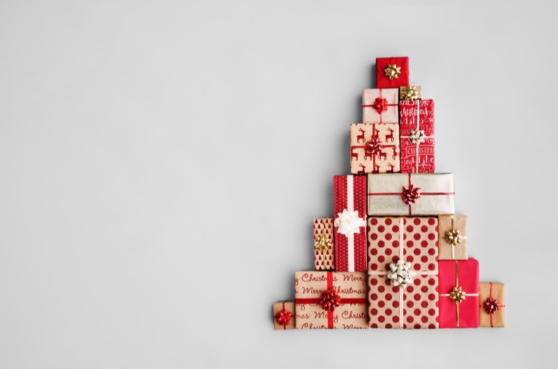 Compras de Natal | Foto de caixas de presente empilhadas em formato de árvore de Natal | Economia e renda extra | Eu Dou Conta